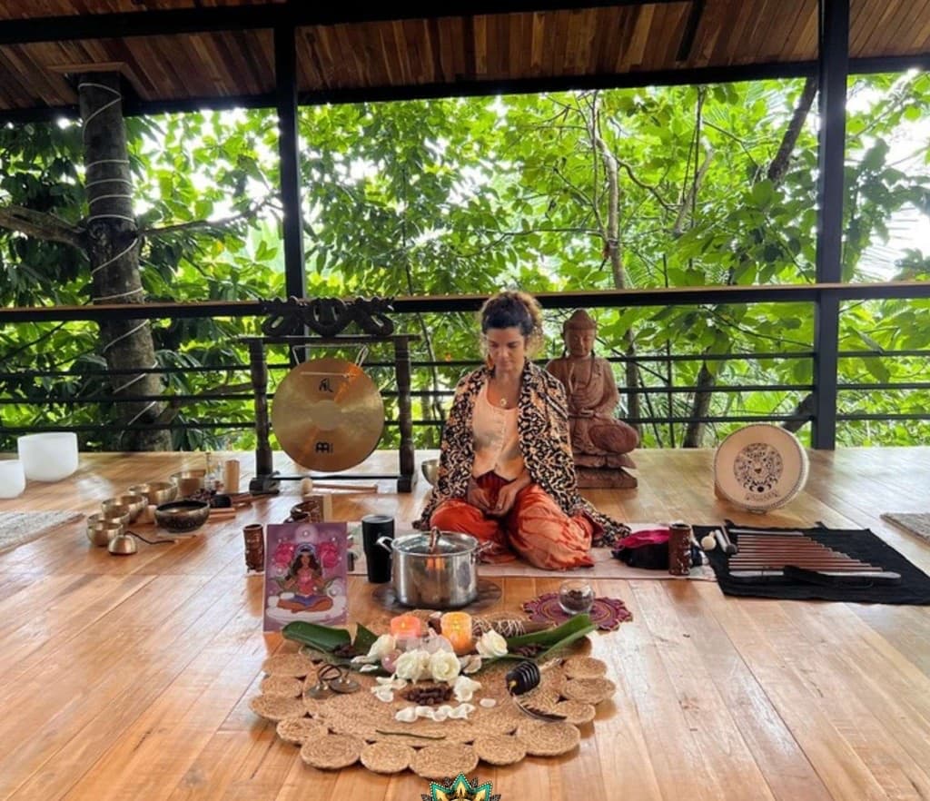 Cacao and sound healing ceremony with singing bowls in an open-air pavilion surrounded by jungle