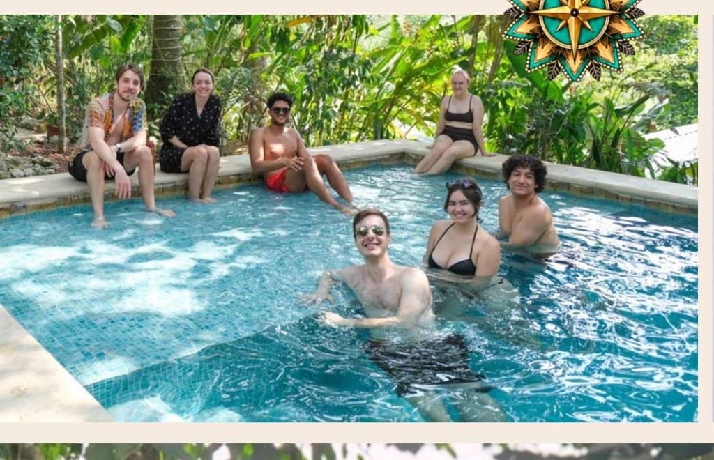 Friends connecting and smiling together in and around the villa pool surrounded by jungle