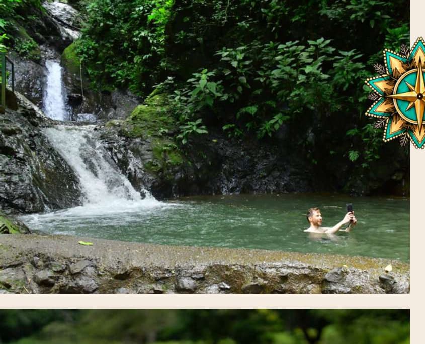 Guest swimming in a natural jungle pool beneath a cascading waterfall in Costa Rica
